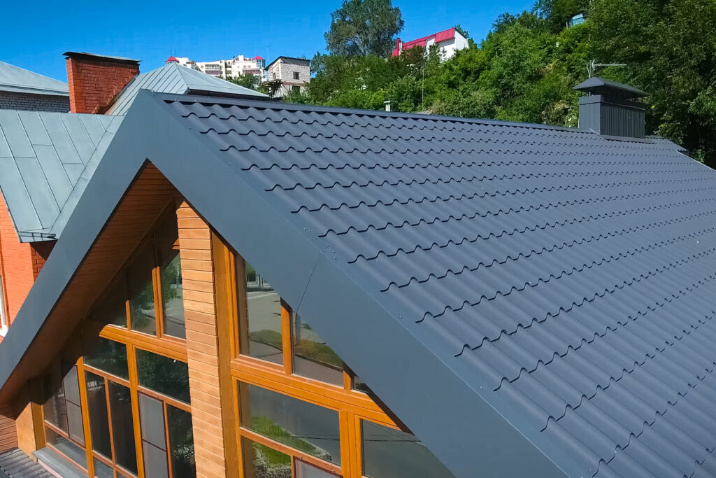 House with  gray metal roofing in Hayden, ID, and large windows on the facade. 