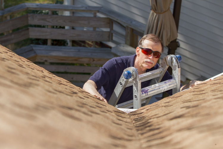 Roofer performing an inspection in Spokane