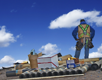 Contractor assessing roofing options on a Spokane Valley home