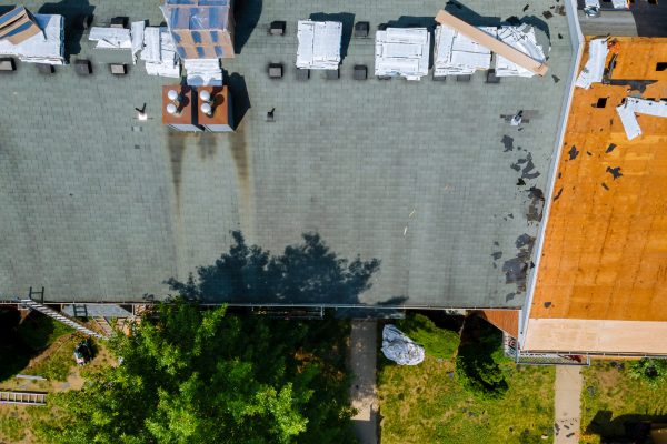 Removal of old roof and replacement with new roof shingle being applied home roof construction site all a new materials