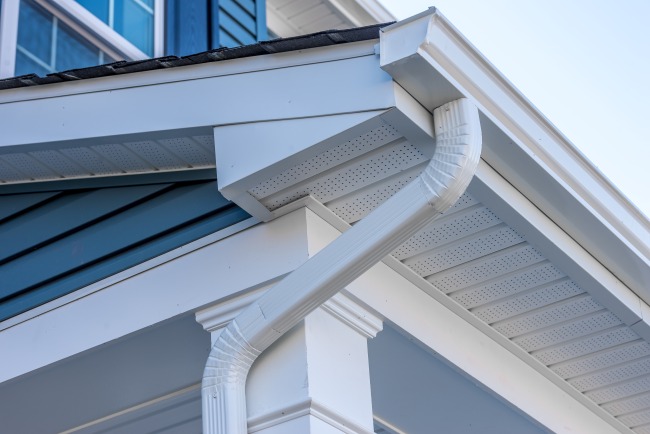 Close up of a white colored gutter on residential home 