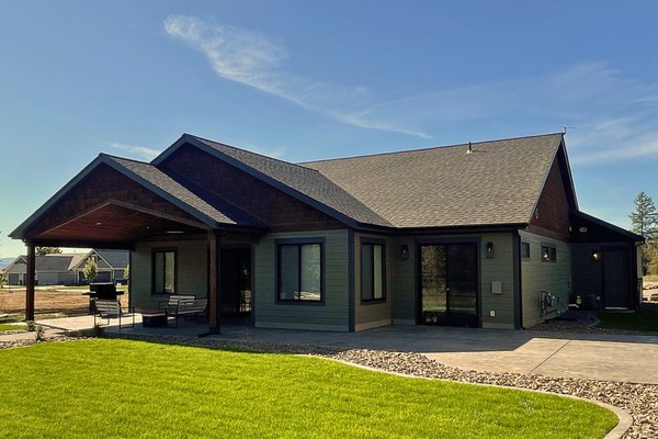 Close up of the outside of a home with new dark blue-ish gray siding installed by {BuisnessName}