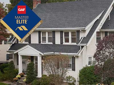 Front view of a typical mid-class home with dark gray GAF shingles on its roof
