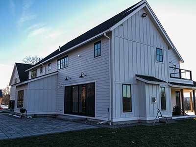 Side view of a typical mid-class home with white James Hardie siding