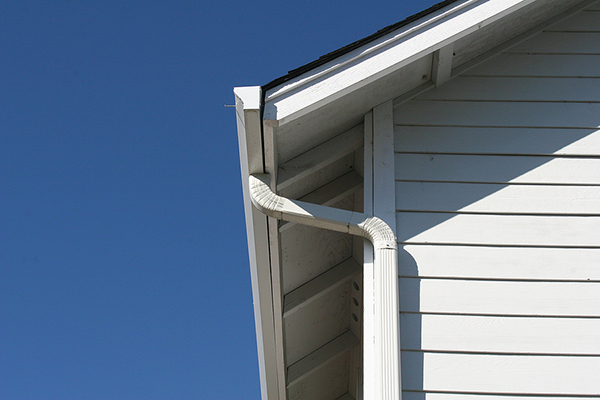 Close up of the outside of a home with new dark blue-ish gray siding installed by {BuisnessName}