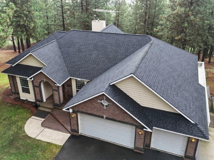 Drone shot of a Mid-class Home with Gray Slate Roof