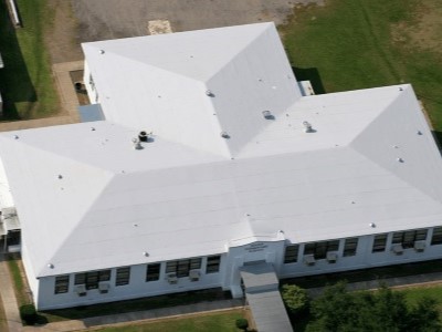 Front view of a typical mid-class home with dark gray GAF shingles on its roof