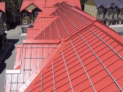 Close up of a red Taylor Metal roofing system on apartments