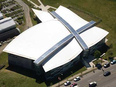 Top view of a white, uniquely shaped commercial roof with Versico products installed